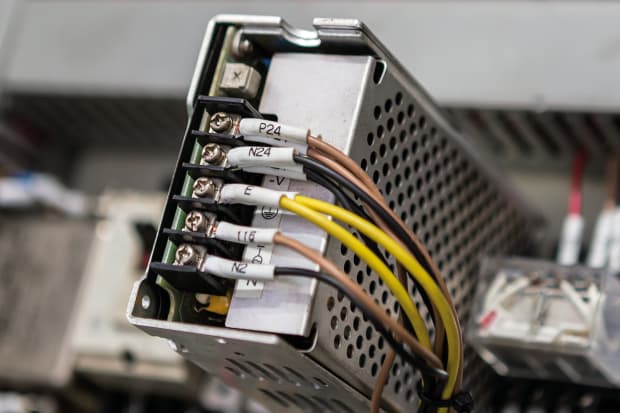 Image of cabling being connected to power supply terminal