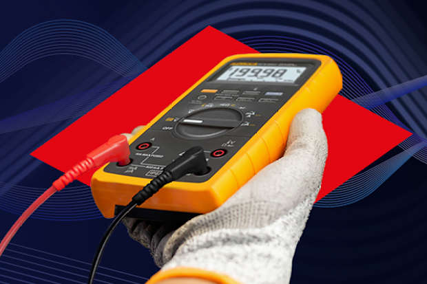 Image of someone holding a multimeter wearing safety gloves