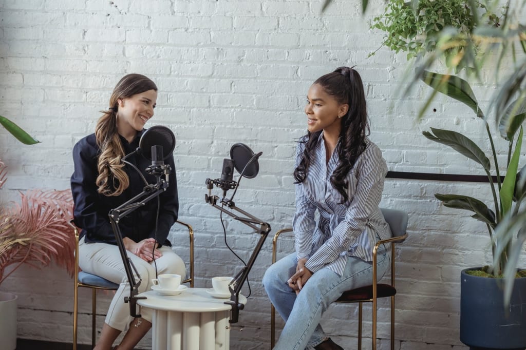 two women on a podcast