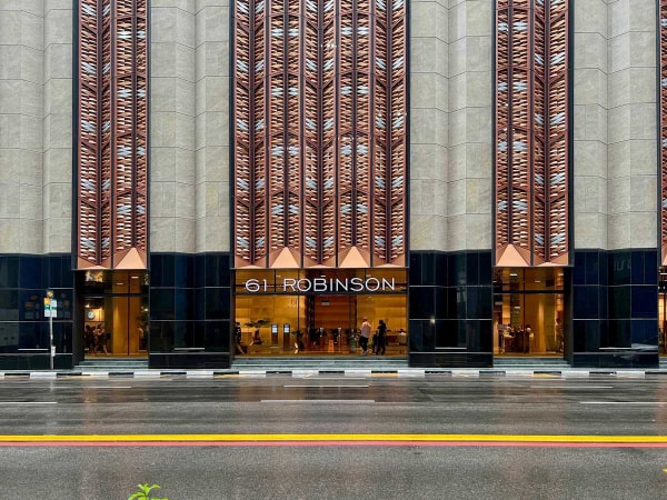 Flexible coworking space at 61 Robinson Road, featuring a modern facade and prime location.