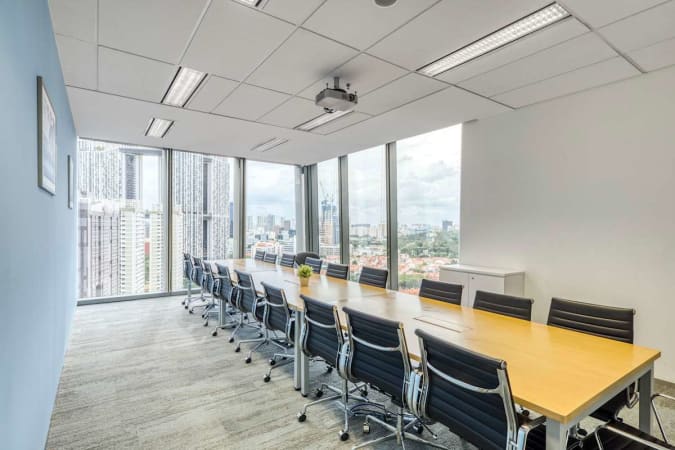 Modern coworking space with panoramic city views and sleek, well-equipped meeting area.
