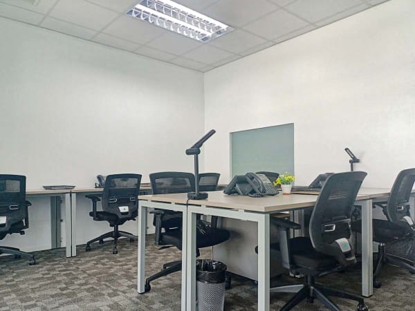 Modern coworking space in Estrella, Manila, featuring ergonomic chairs and ample desks.