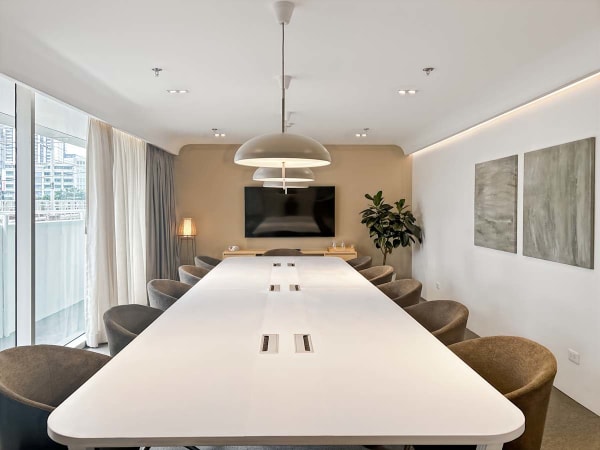 Elegant meeting room with modern lighting, spacious seating, and natural light. Ideal for collaboration.