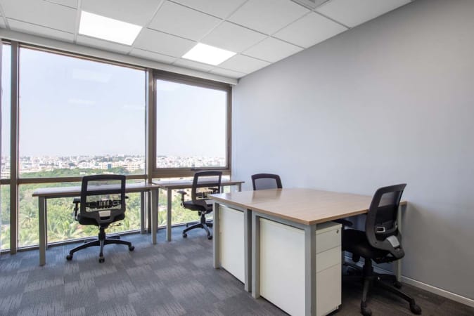 Bright, airy coworking space with modern desks and city views on JNTU Road.