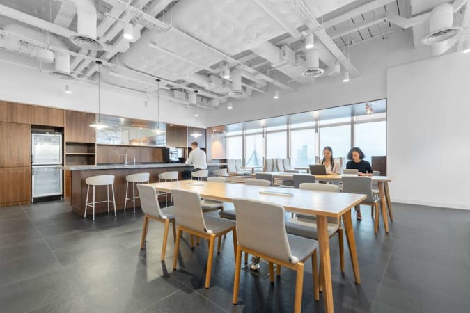 Modern coworking space with natural light, open layout, and sleek kitchen area on Hennessy Road.