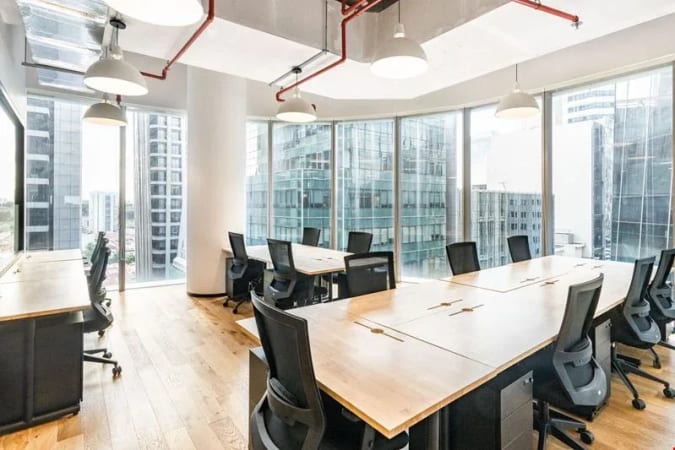 Bright coworking space with modern furnishings and panoramic city views in Robinson Road, Singapore.