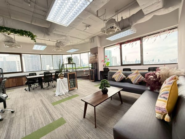 Bright, flexible coworking space with city views, modern decor, and cozy seating in Din Daeng.