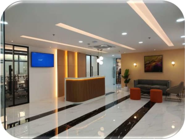 Sleek coworking space with modern reception, cozy seating, and vibrant lighting in Taguig.