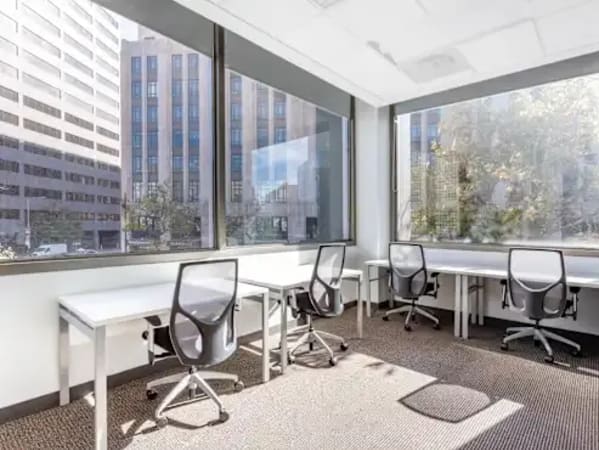 Bright, airy coworking space with modern desks and ergonomic chairs, ideal for productivity.