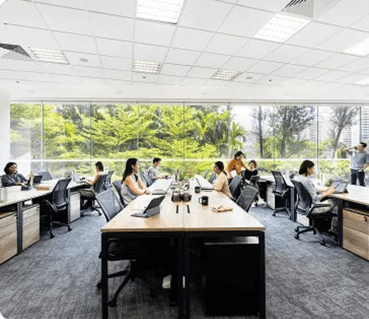 Bright coworking space with large windows and modern furnishings on Gateway Drive, Singapore.