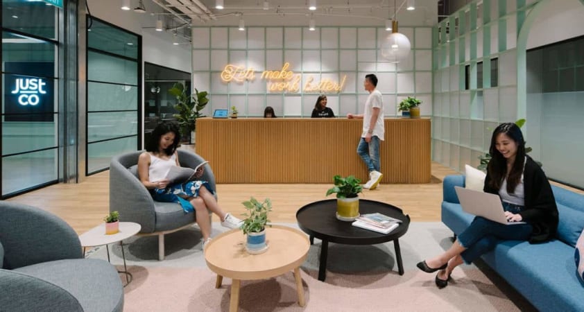 Stylish coworking lounge with modern seating and vibrant decor, ideal for dynamic collaboration.
