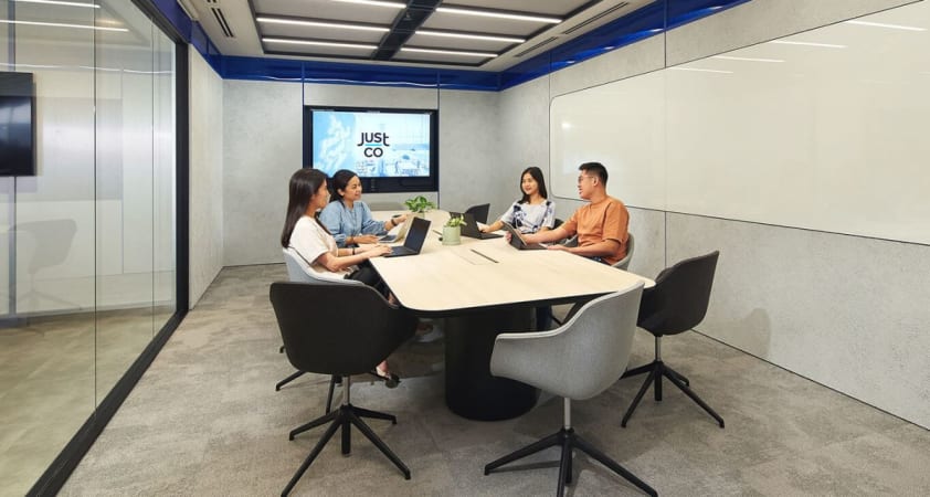 Modern meeting room with ergonomic chairs, sleek table, and high-tech AV setup in One-North Crescent.