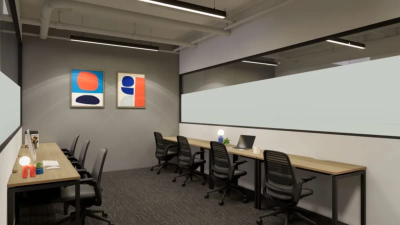 Modern coworking office with ample desks, ergonomic chairs, and contemporary artwork for inspiration.