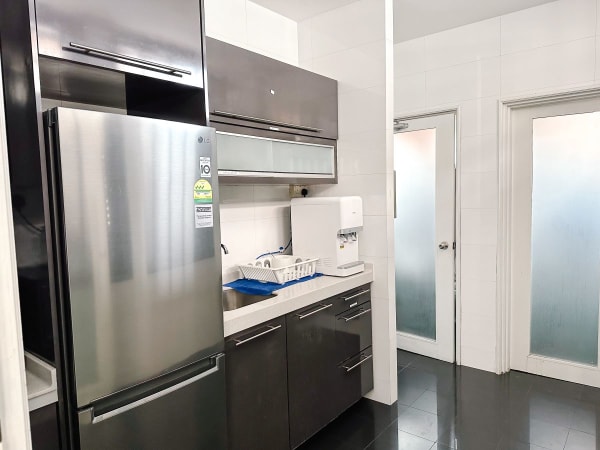 Modern coworking kitchen with sleek appliances and ample storage on Bukit Pasoh Road.