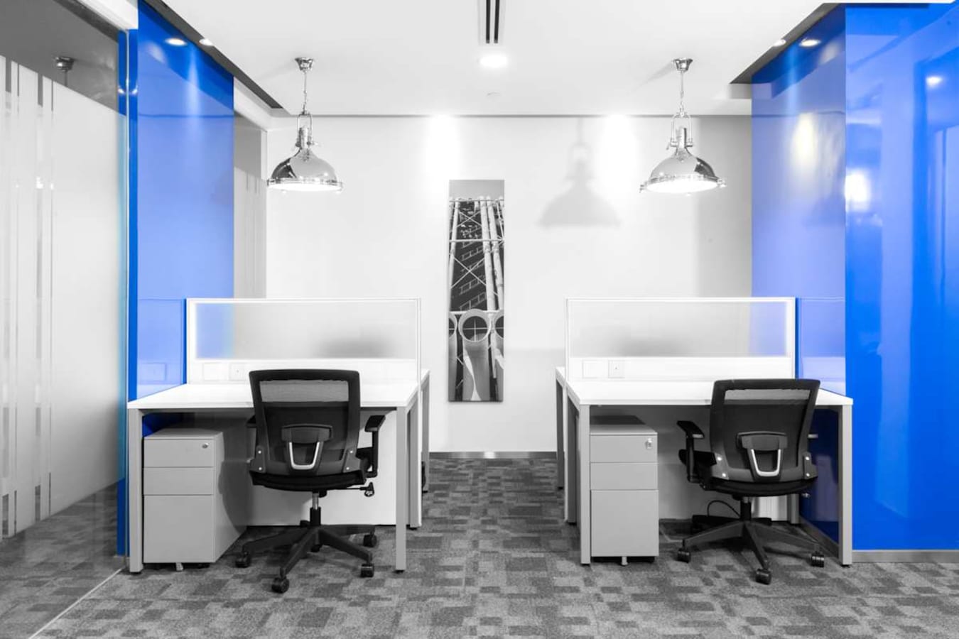Modern coworking space with sleek design, bright blue accents, and ample natural light.