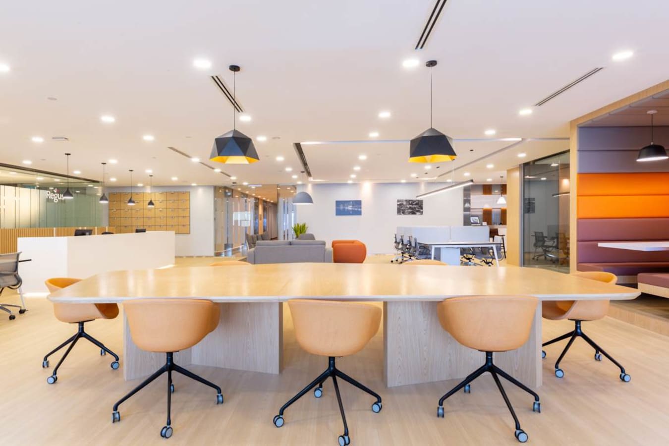 Modern coworking space with vibrant seating, ample lighting, and a collaborative layout.