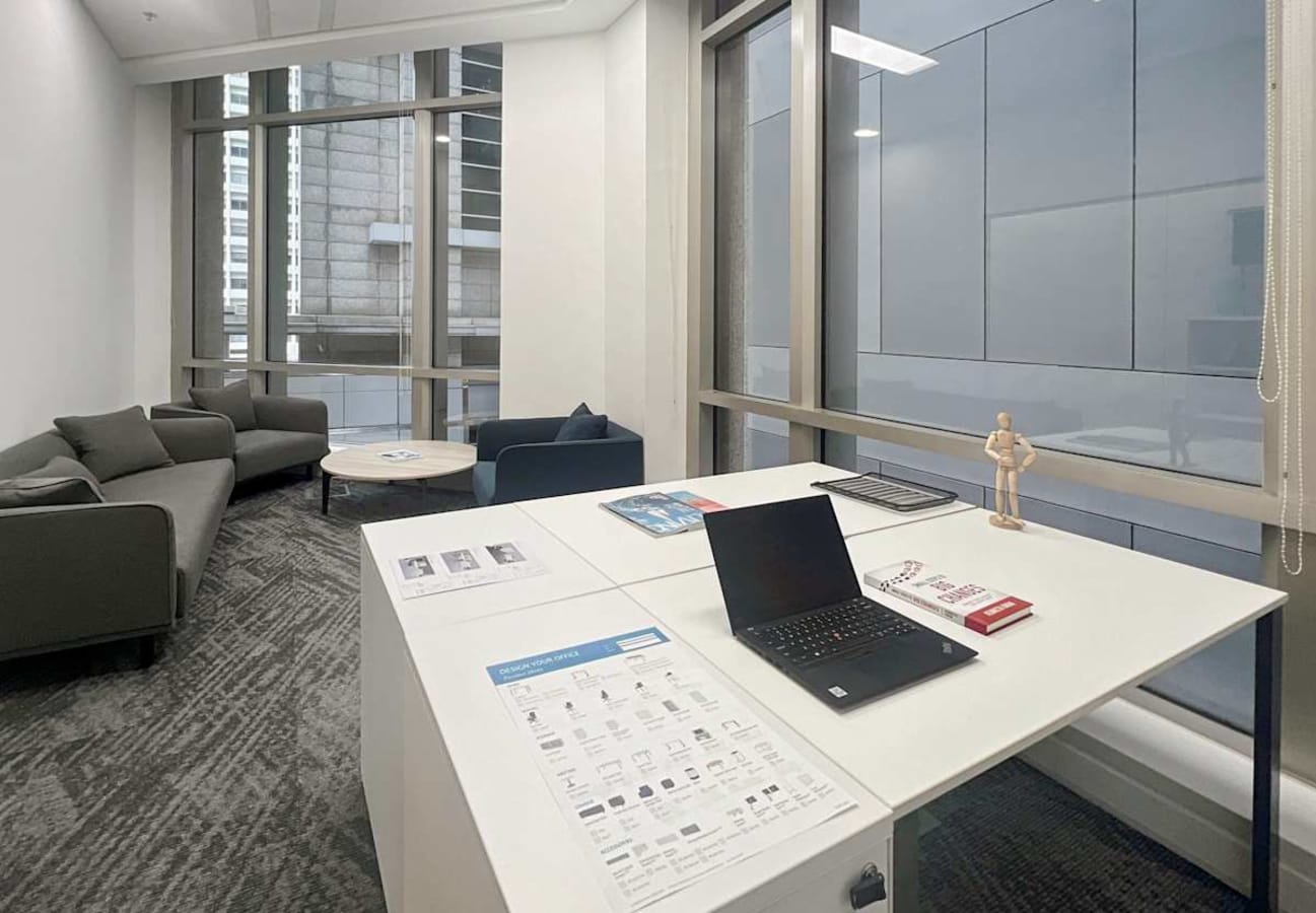 Modern coworking space with natural light, cozy seating area, and workstations on Robinson Road.