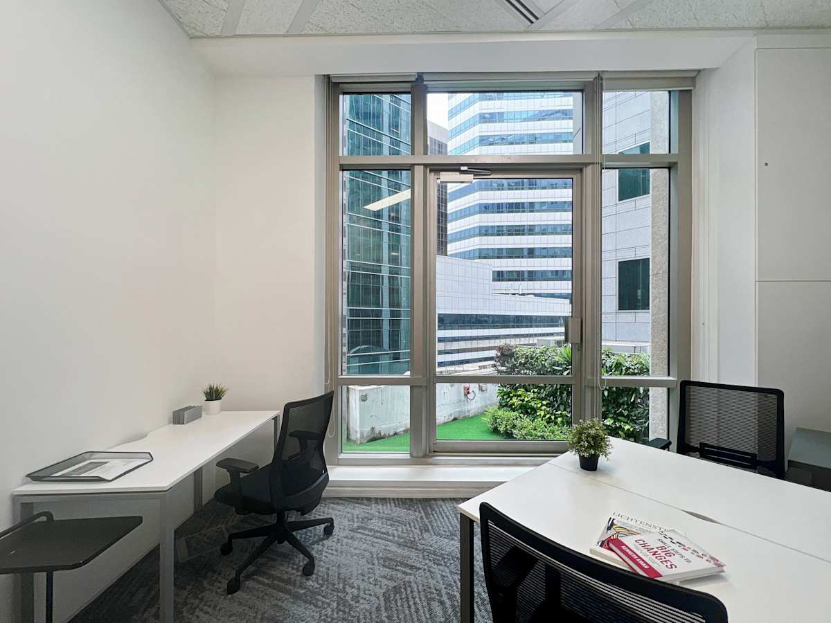 Bright coworking space with large windows, modern desks, and ergonomic chairs on Robinson Road.