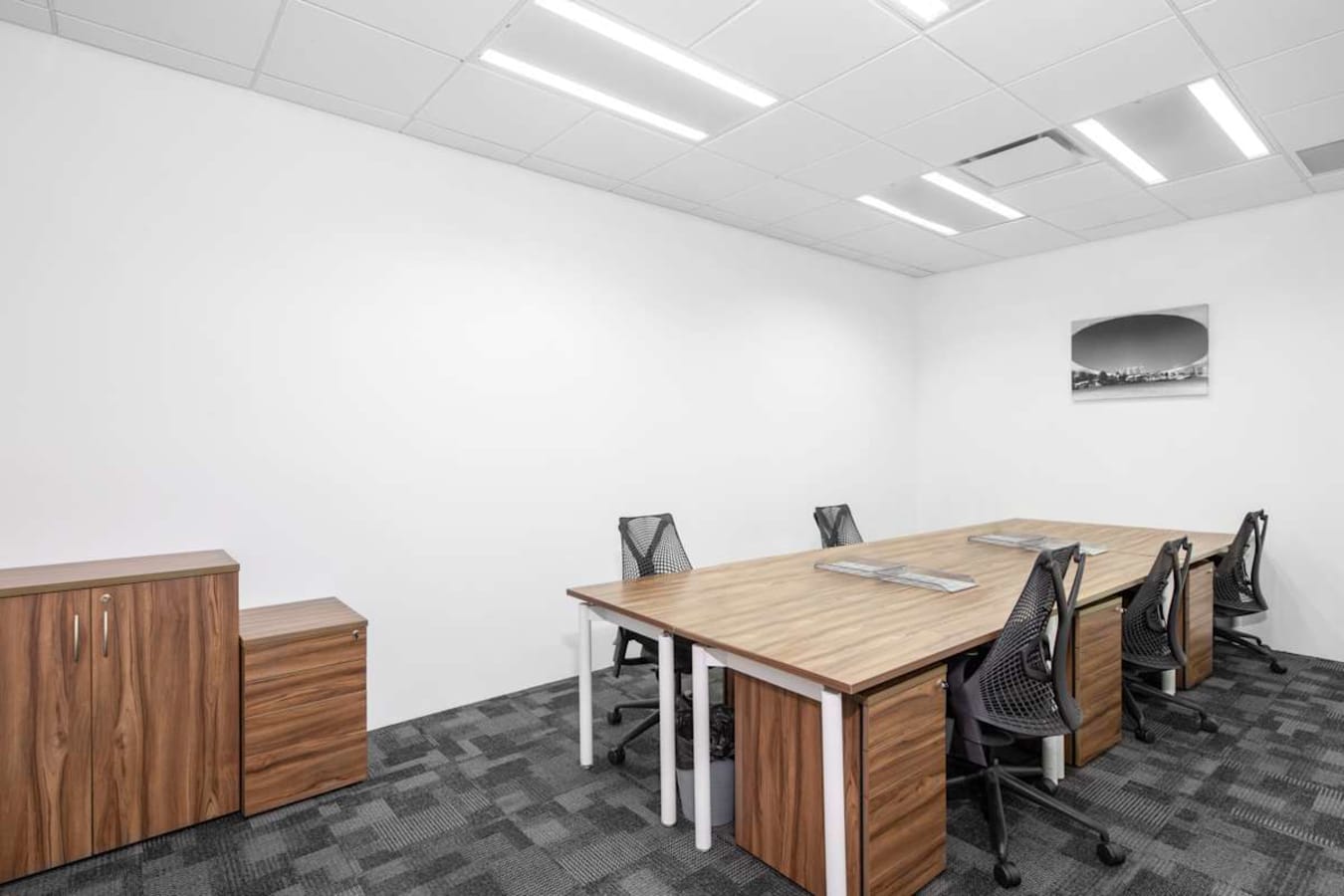 Sleek coworking space with modern desks and ergonomic chairs in Raffles Place, Singapore.