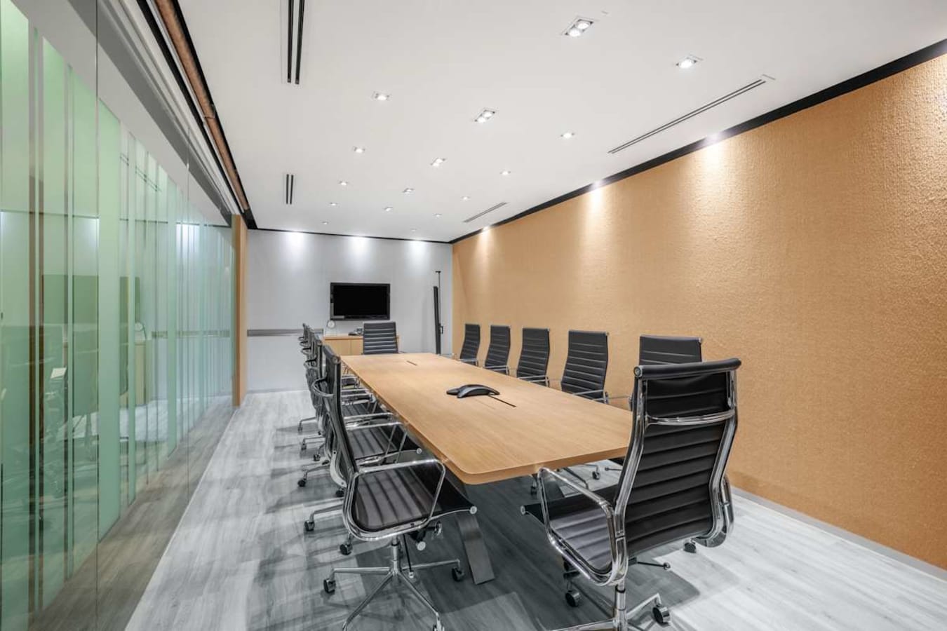 Sleek conference room with modern seating and a large table, ideal for collaborative meetings.