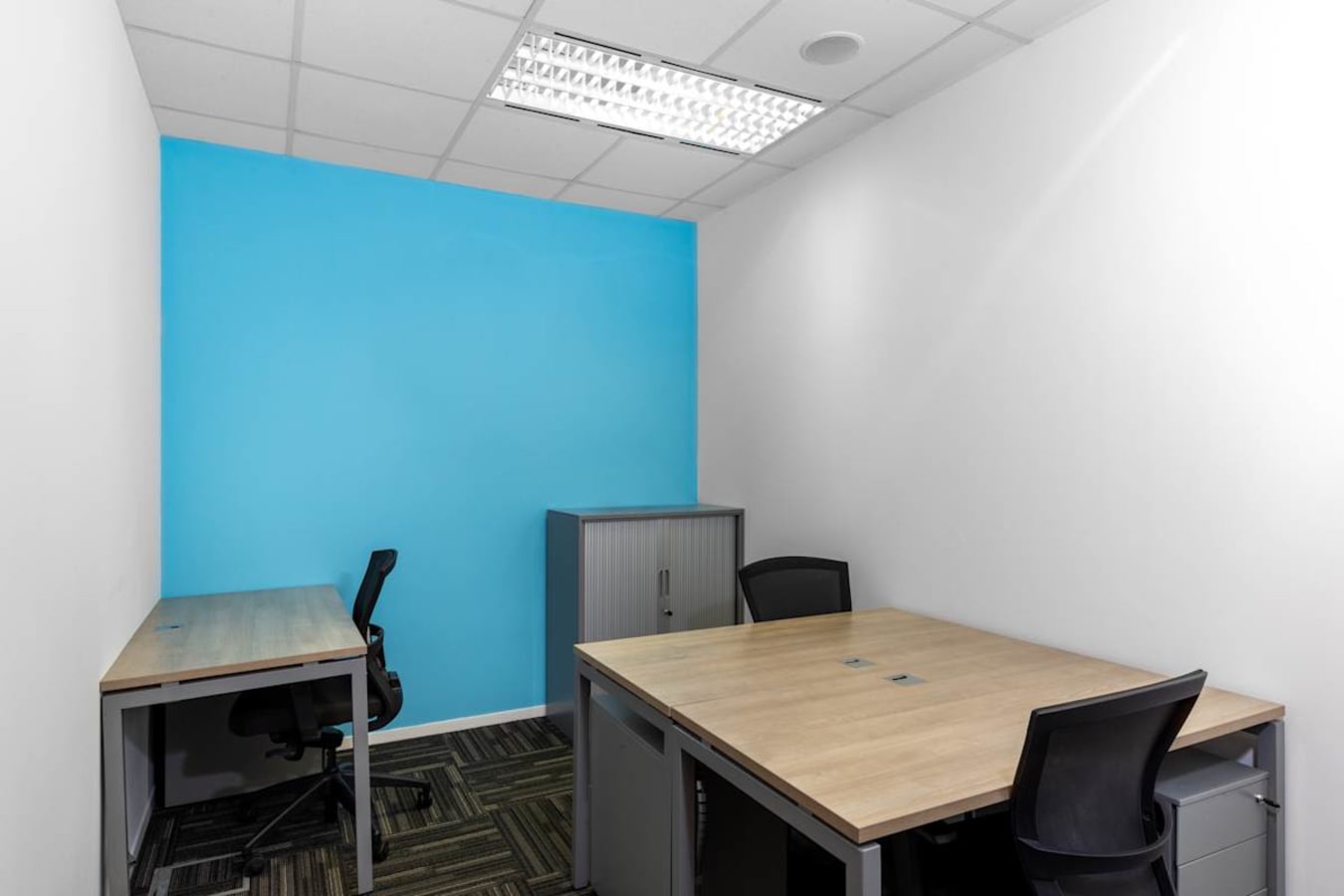 Modern coworking space with sleek desks, ergonomic chairs, and vibrant decor in Orchard Road.