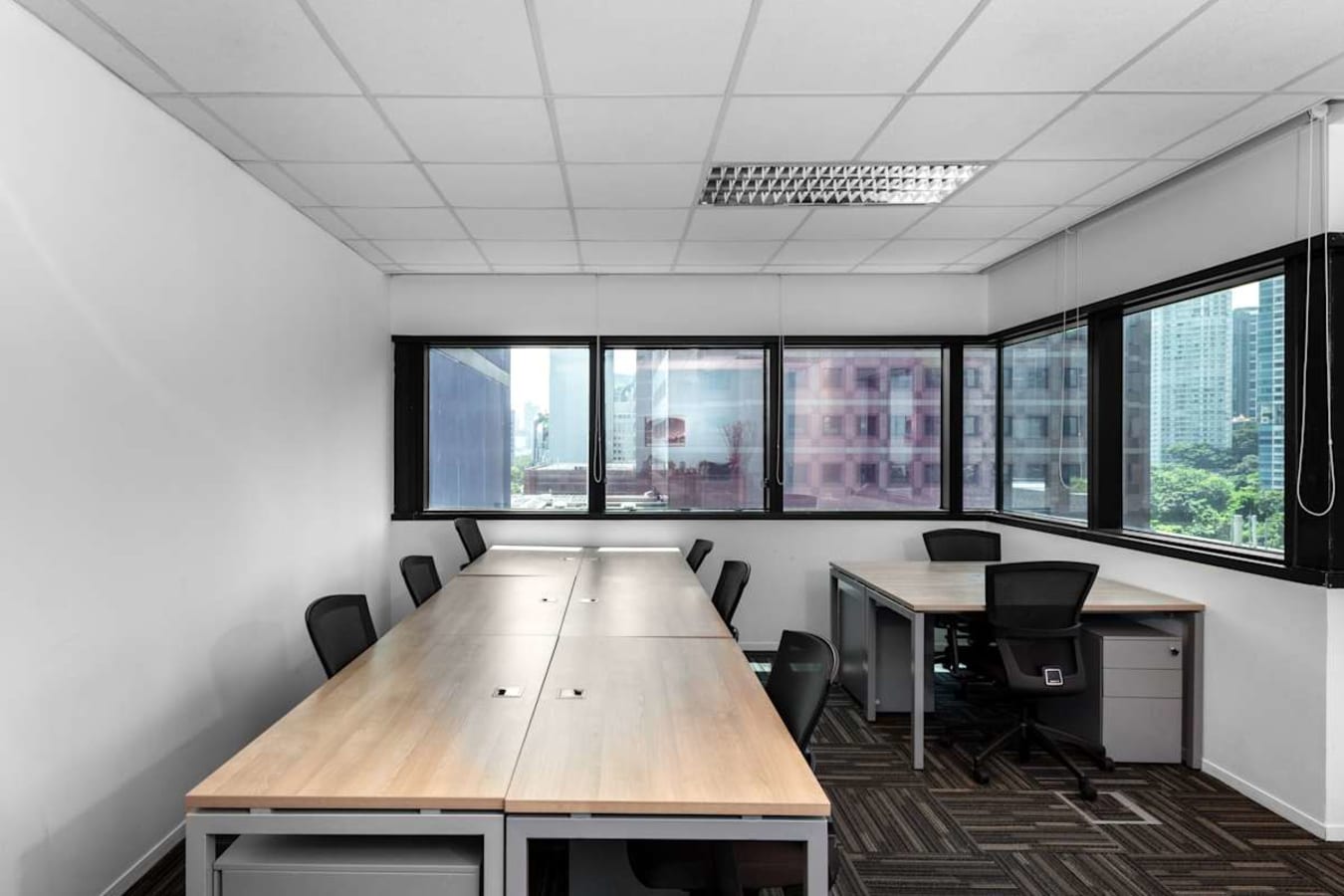 Bright coworking space with modern desks and city views in Orchard Road, Singapore.