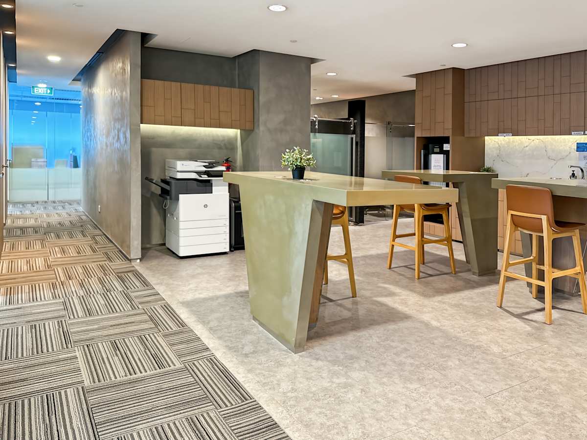 Modern coworking space with sleek design, communal seating, and office amenities on Orchard Road.
