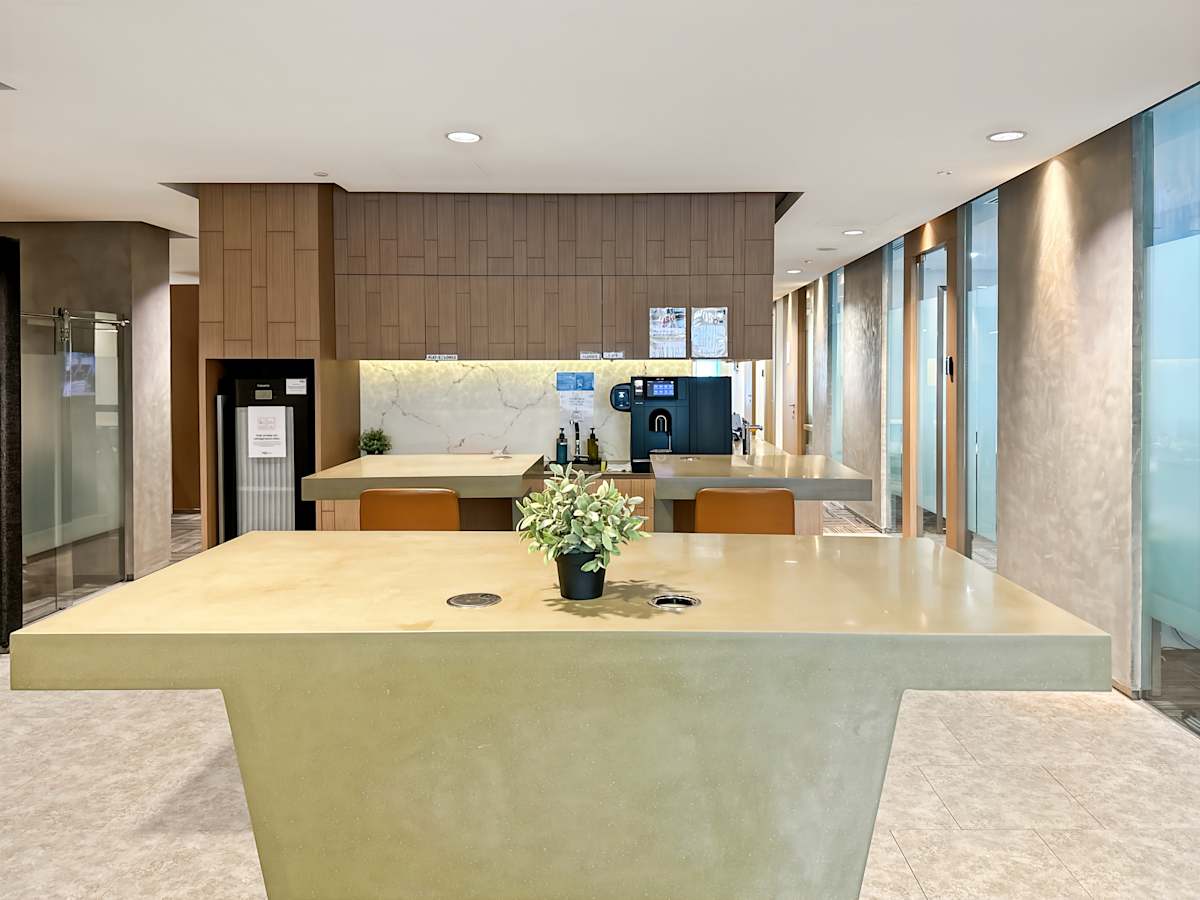 Sleek coworking breakout area with modern fixtures and a coffee station on Orchard Road.