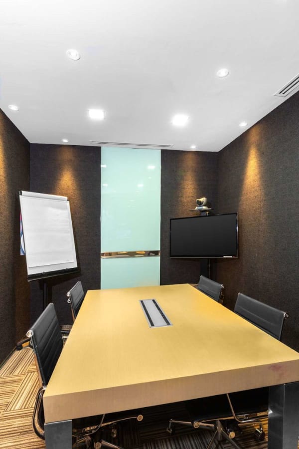 Modern meeting room with sleek table, ergonomic chairs, and presentation tools in Orchard Road space.