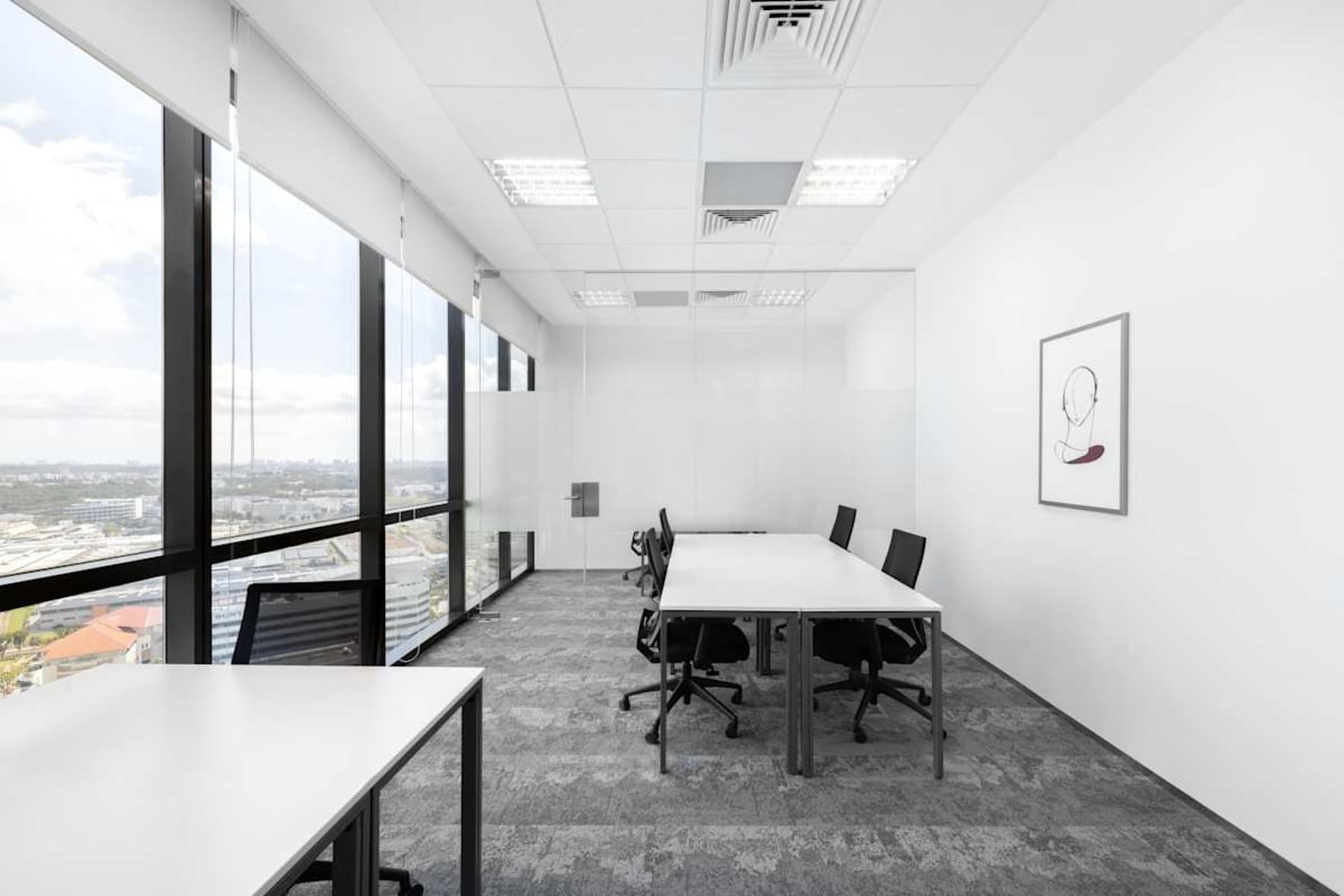 Bright, modern coworking space with large windows and versatile desk layouts in Venture Drive.