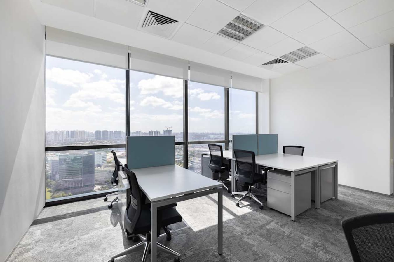Bright coworking space with city views, modern desks, and ergonomic chairs at Venture Drive.