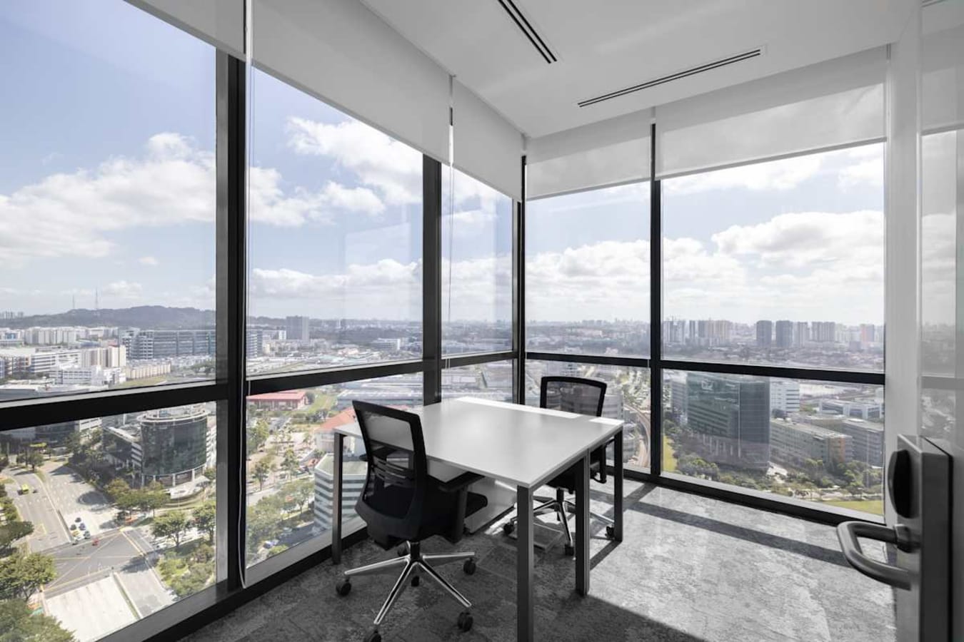 Bright corner office with panoramic city views and modern furnishings in Venture Drive, Singapore.