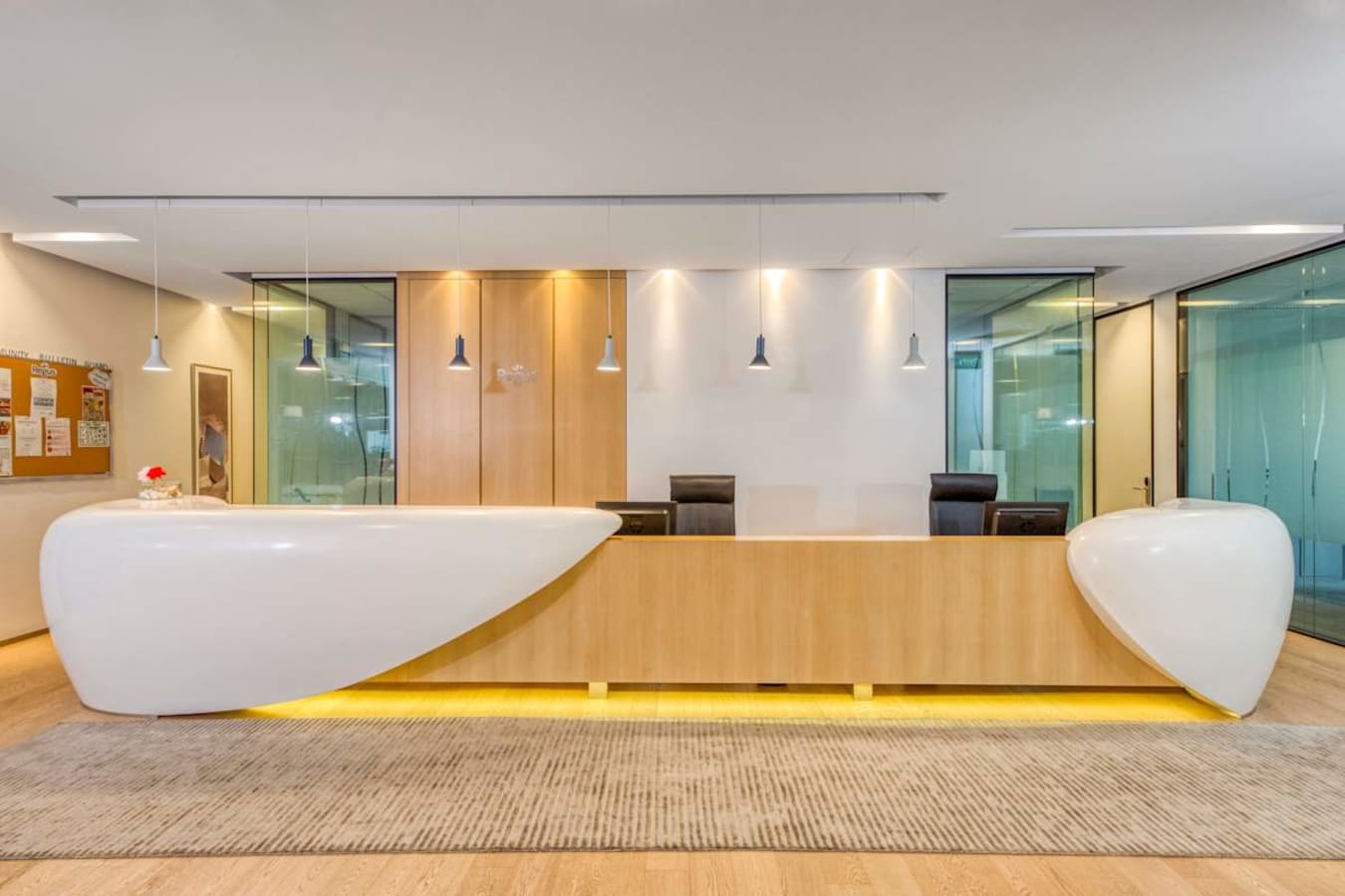Sleek reception area with modern design and warm lighting in a prime coworking space on Wallich Street.