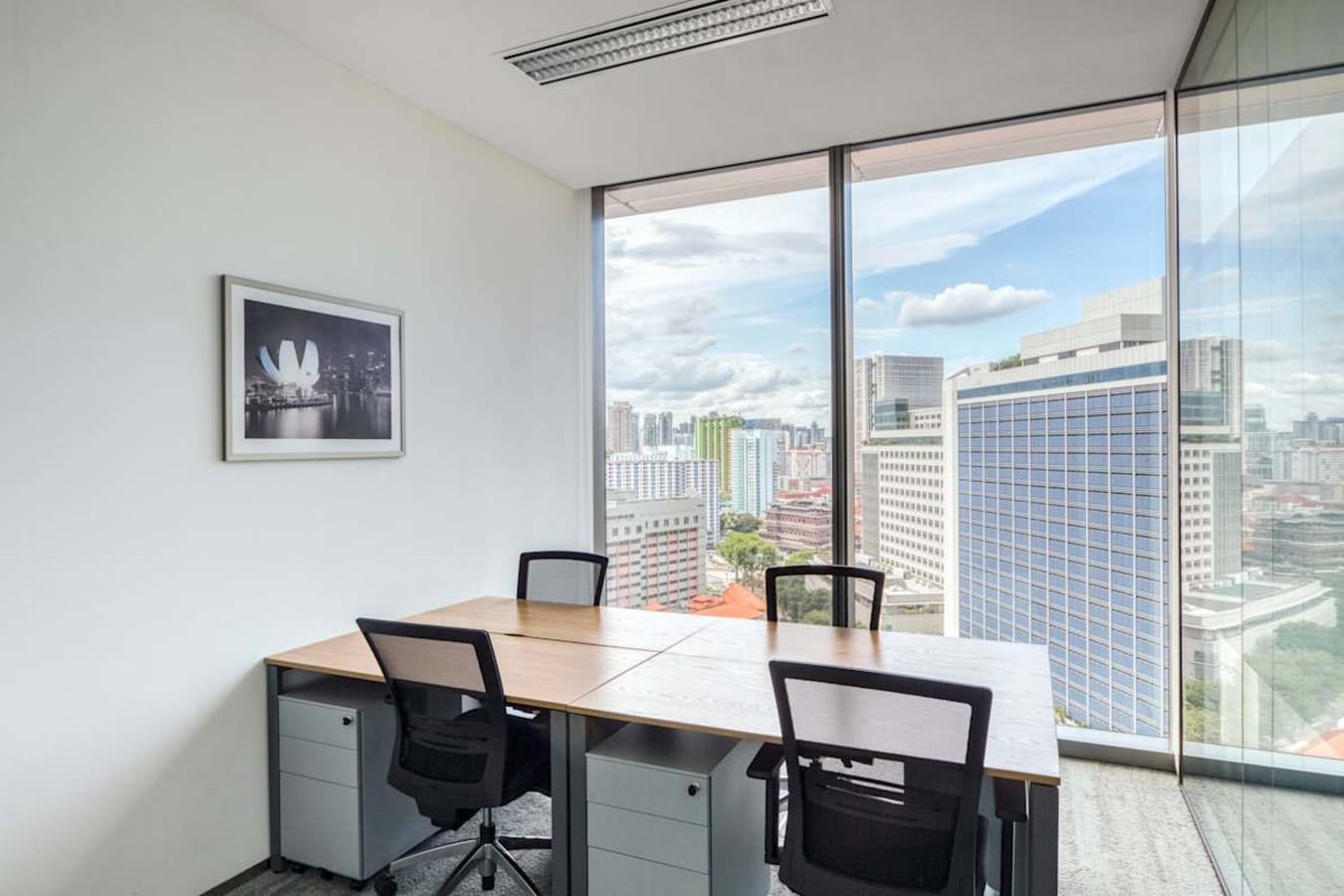 Bright workspace with city views, modern desks, and ergonomic chairs on Wallich Street, Singapore.