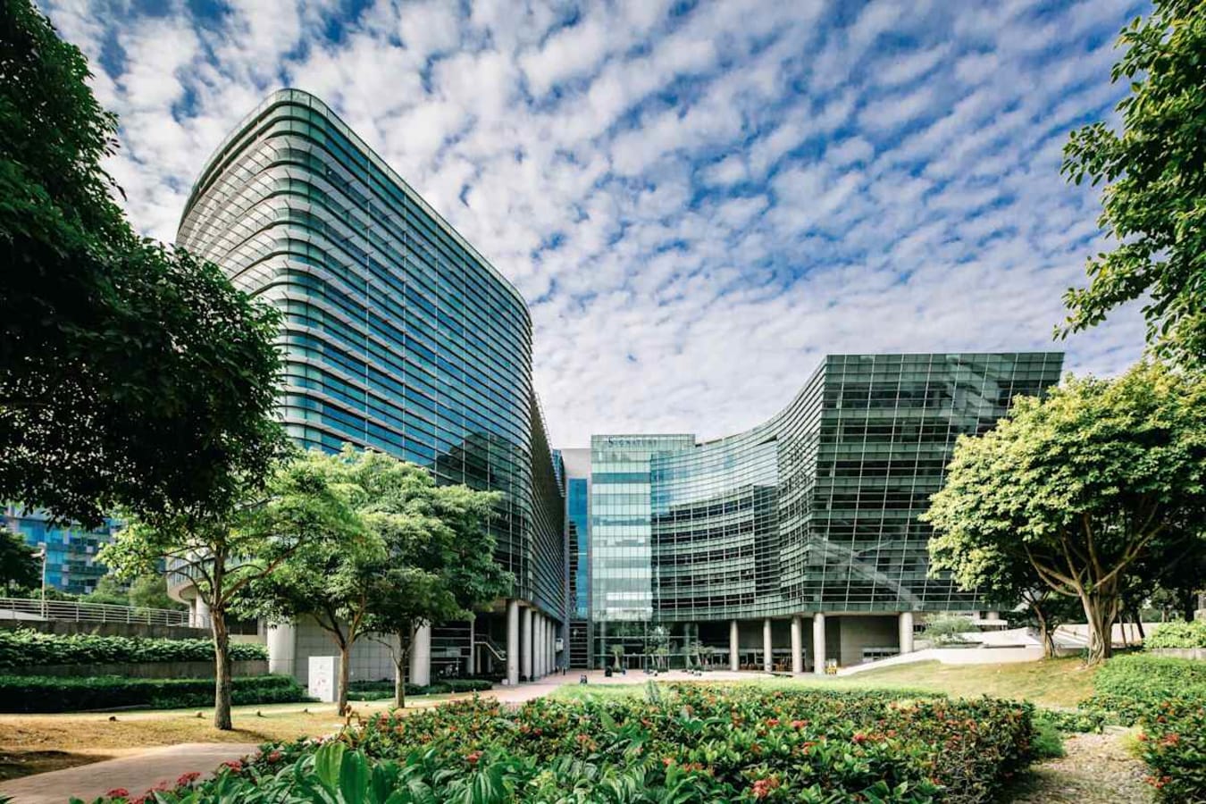 Modern coworking space in Changi Business Park, surrounded by lush greenery and striking architecture.