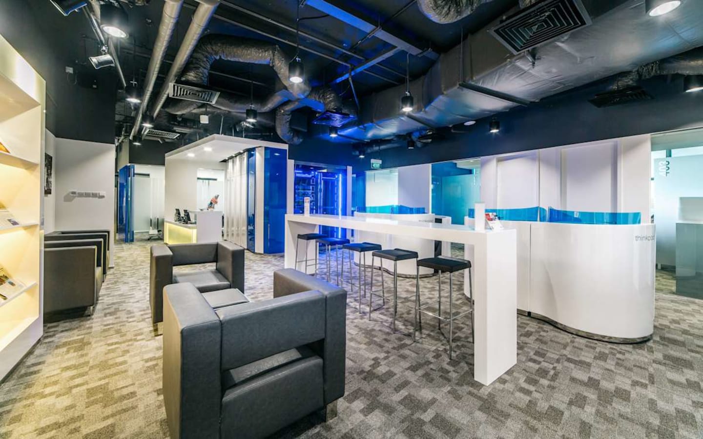 Modern coworking space with sleek furniture and vibrant lighting in Changi Business Park.