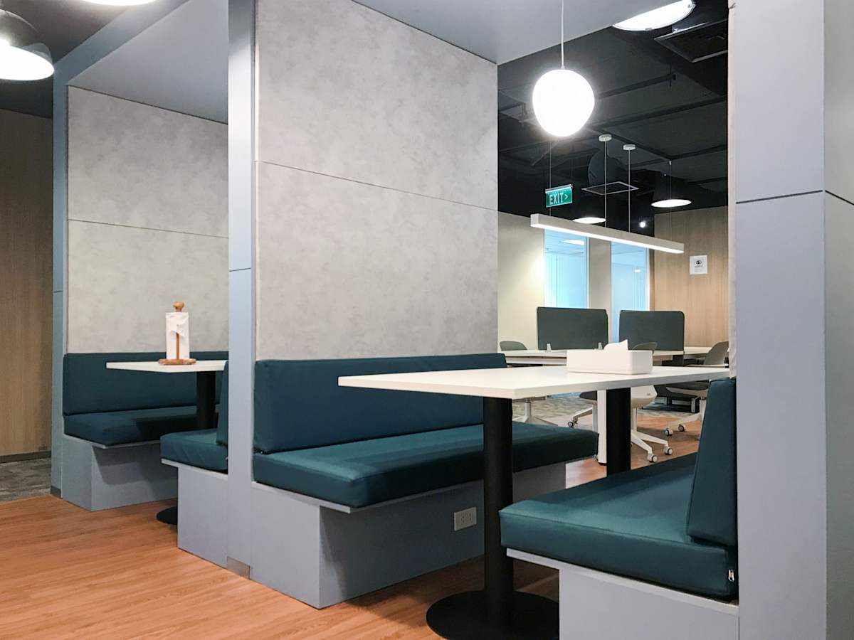 Sleek, modern coworking booths with plush seating and ample lighting in Metro Manila.