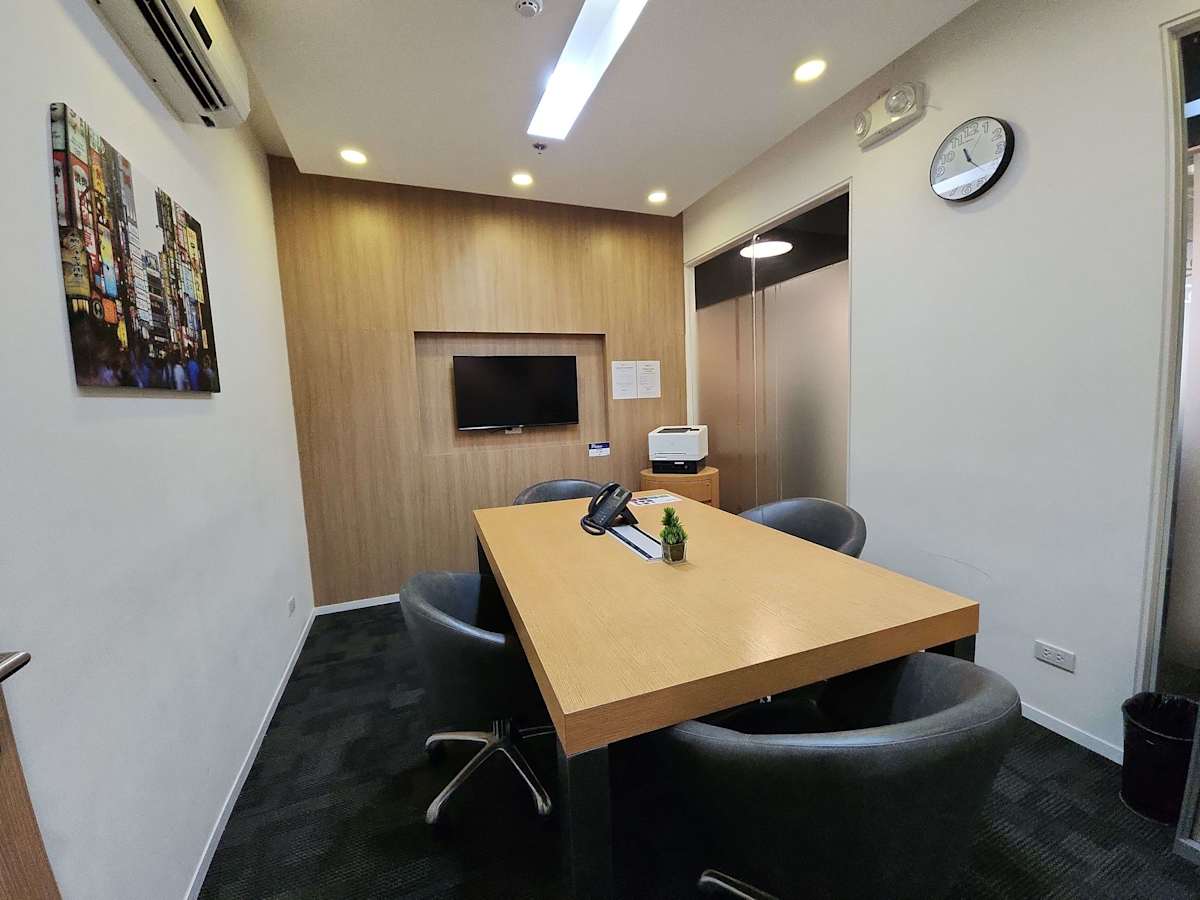 Sleek meeting room with modern amenities and stylish decor in a vibrant coworking space.