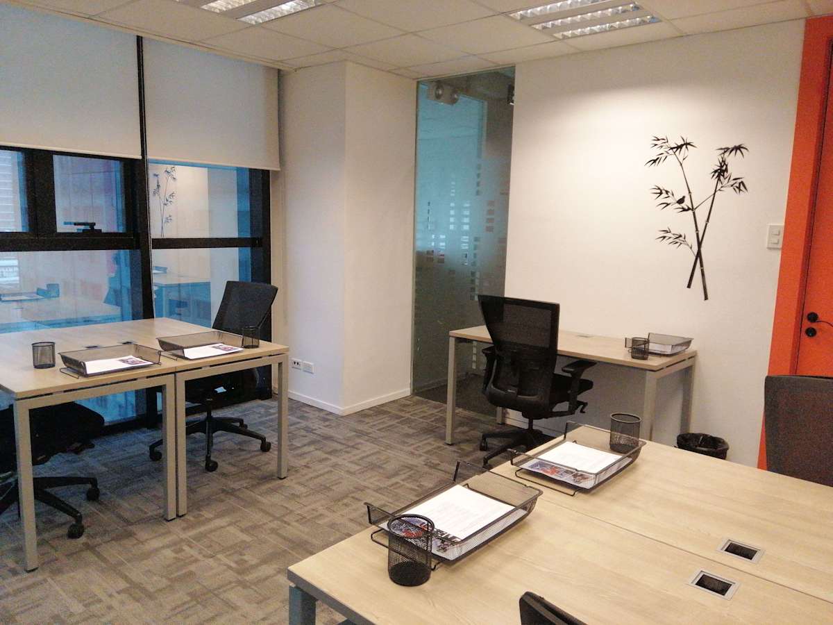 Modern coworking space with ample natural light, sleek desks, and ergonomic chairs in Central Visayas.