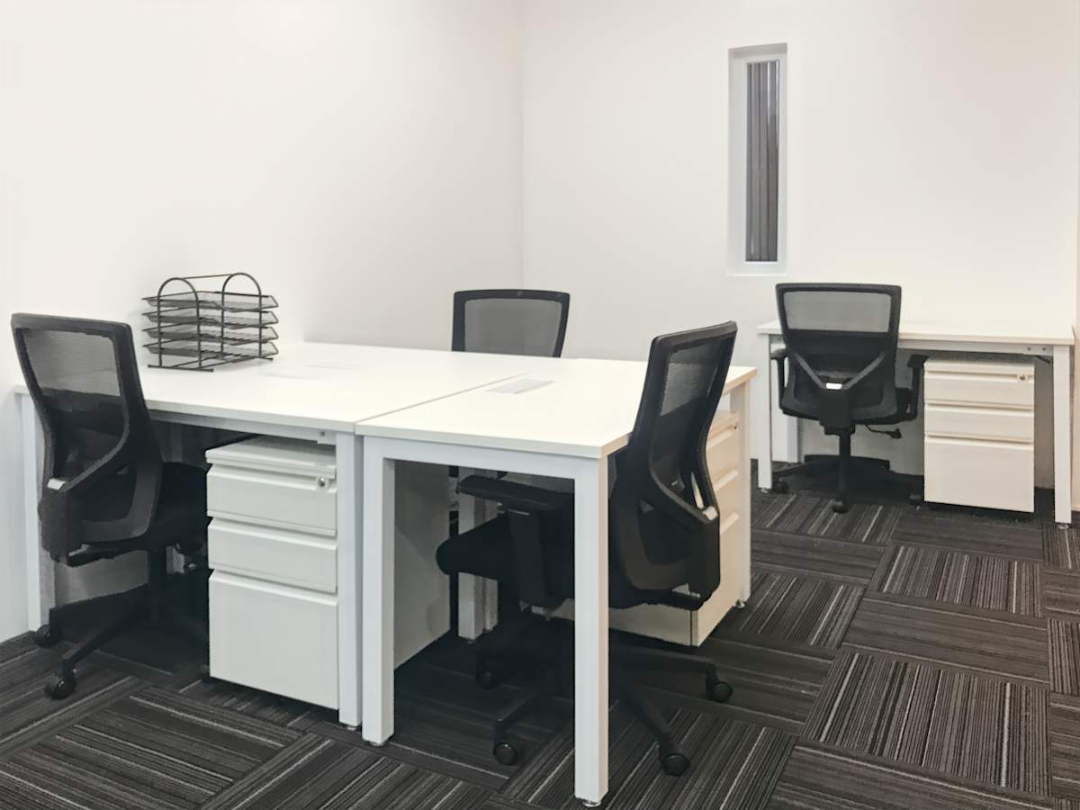 Modern office with sleek workstations and ergonomic chairs, ideal for focused productivity.