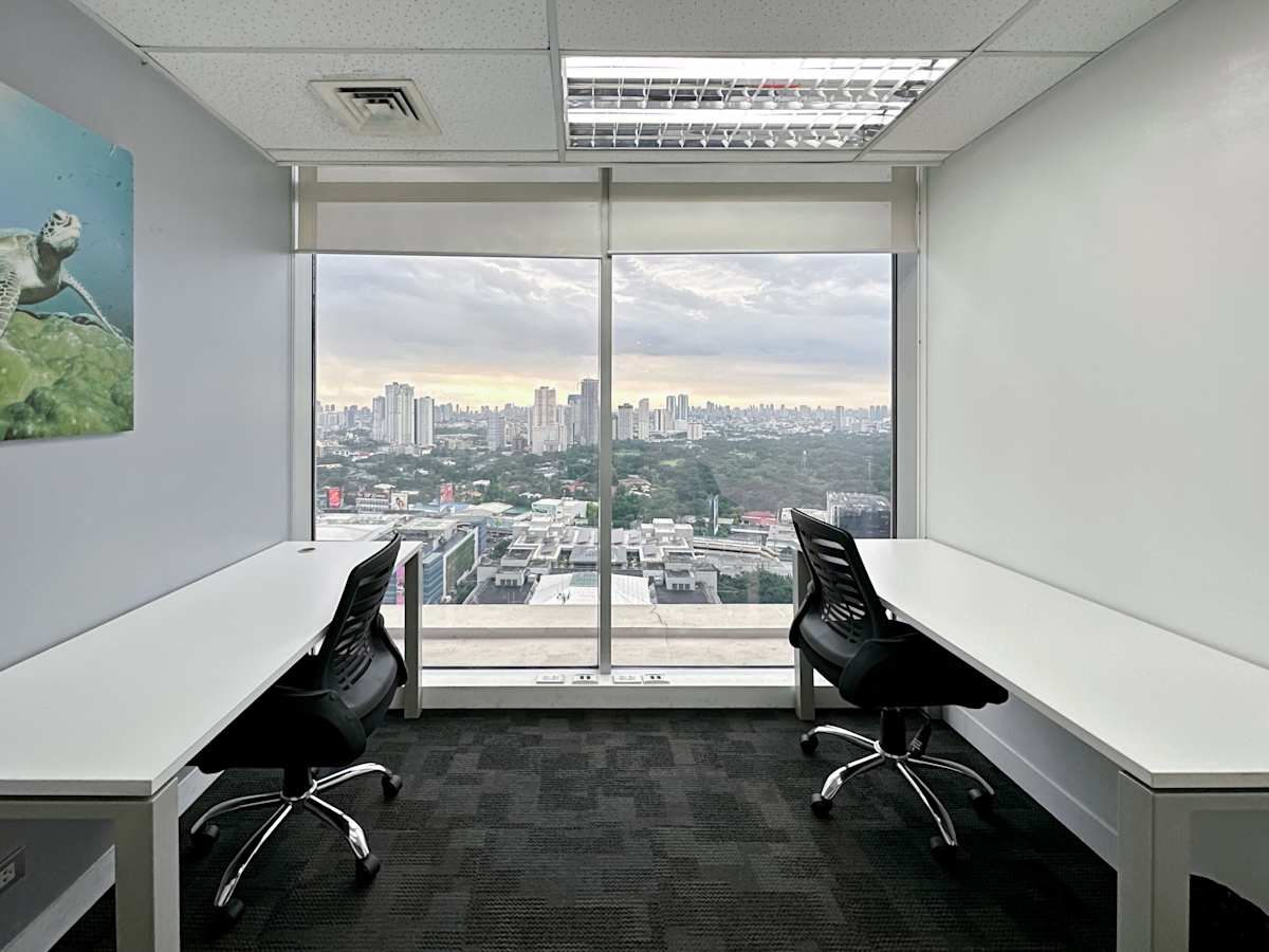 Bright office with cityscape views, modern desks, and ergonomic chairs. Ideal for productivity.
