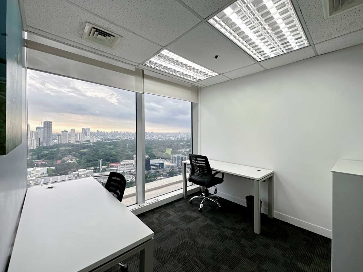 Bright office with stunning city views, modern desks, and ergonomic chairs for productivity.