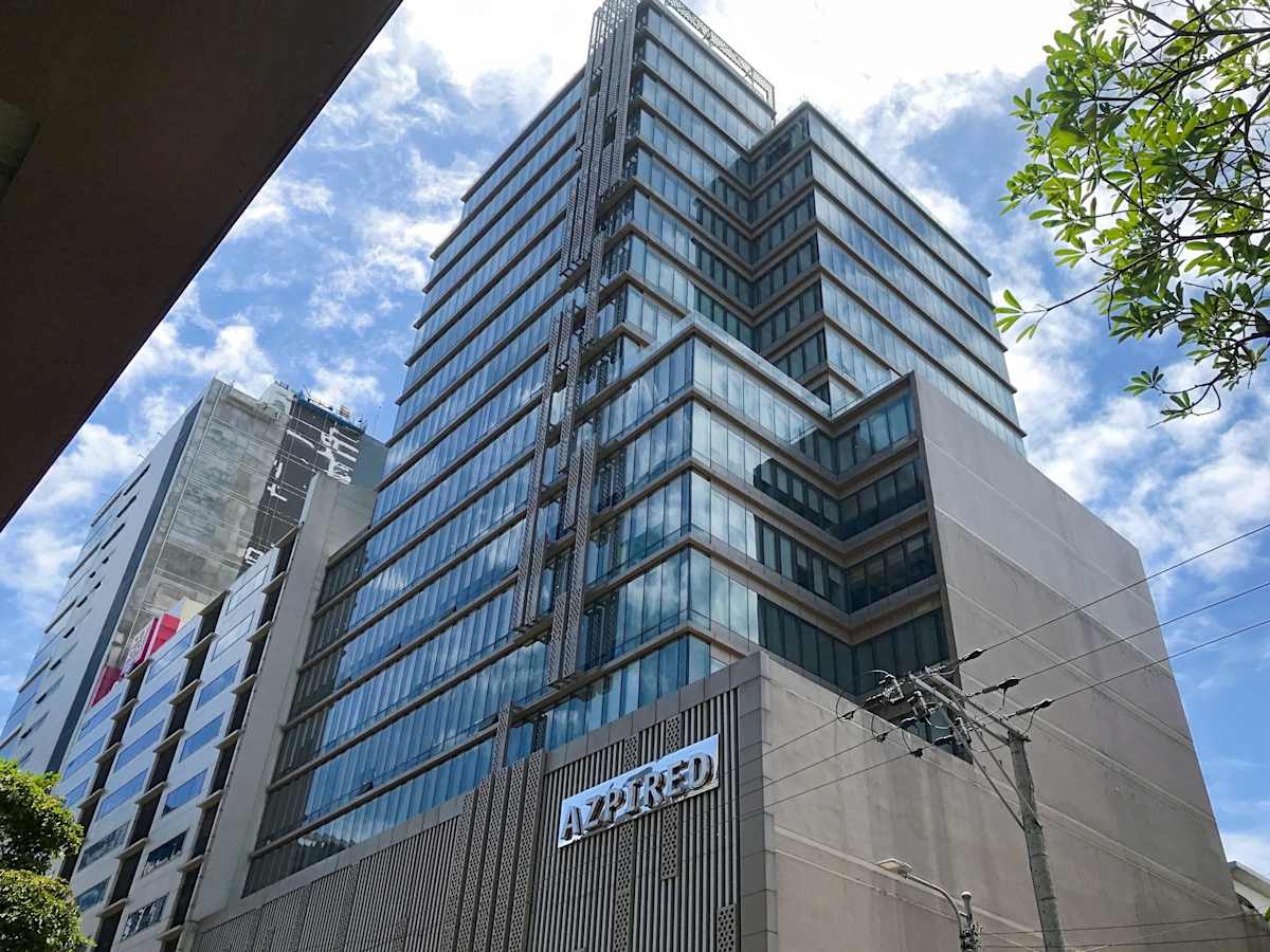 Modern high-rise office building with sleek glass façade and excellent natural lighting.