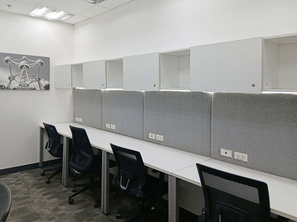 Modern coworking space with sleek workstations and ample storage. Ideal for productivity.