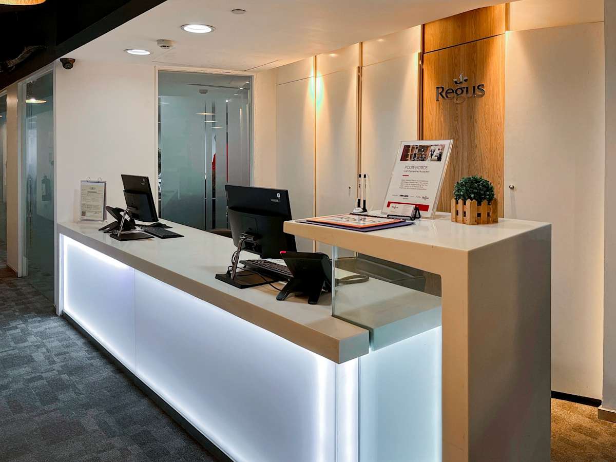 Modern reception area with illuminated desk and dual workstations. Ideal for welcoming guests.