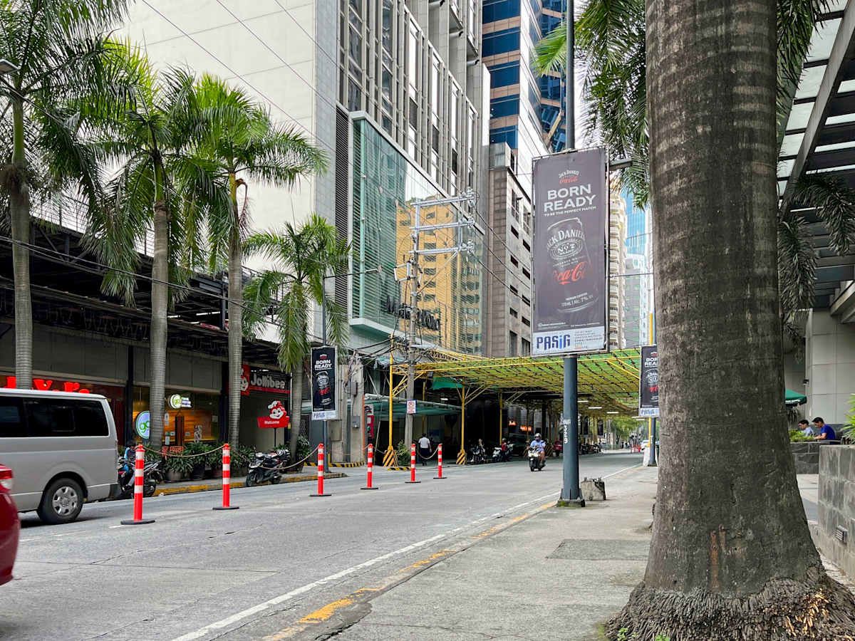 Modern office location with easy urban access, surrounded by shops and vibrant city life.