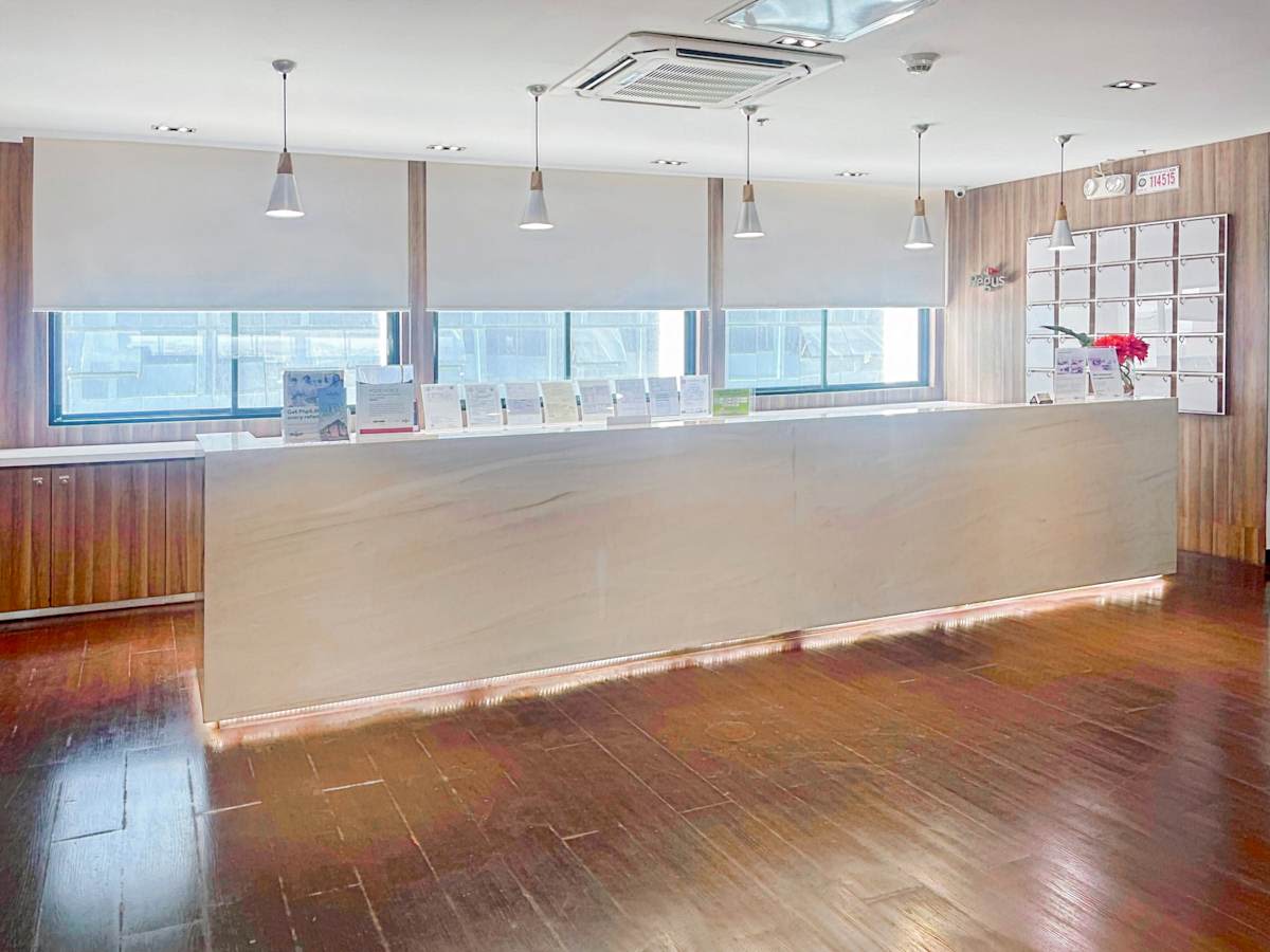 Bright, spacious reception with sleek countertop and ample natural light. Ideal for welcoming guests.