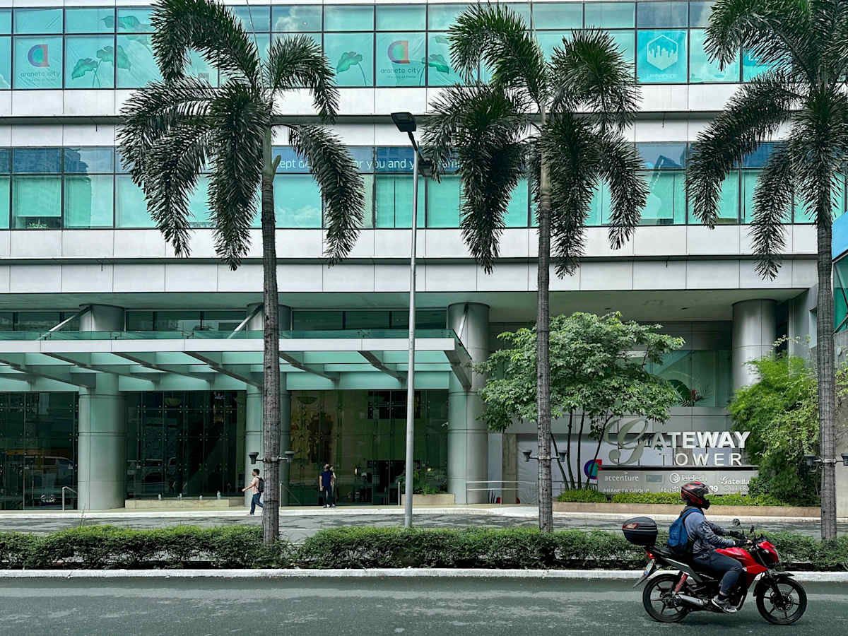 Contemporary office space in Gateway Tower, featuring a modern exterior and lush surroundings.