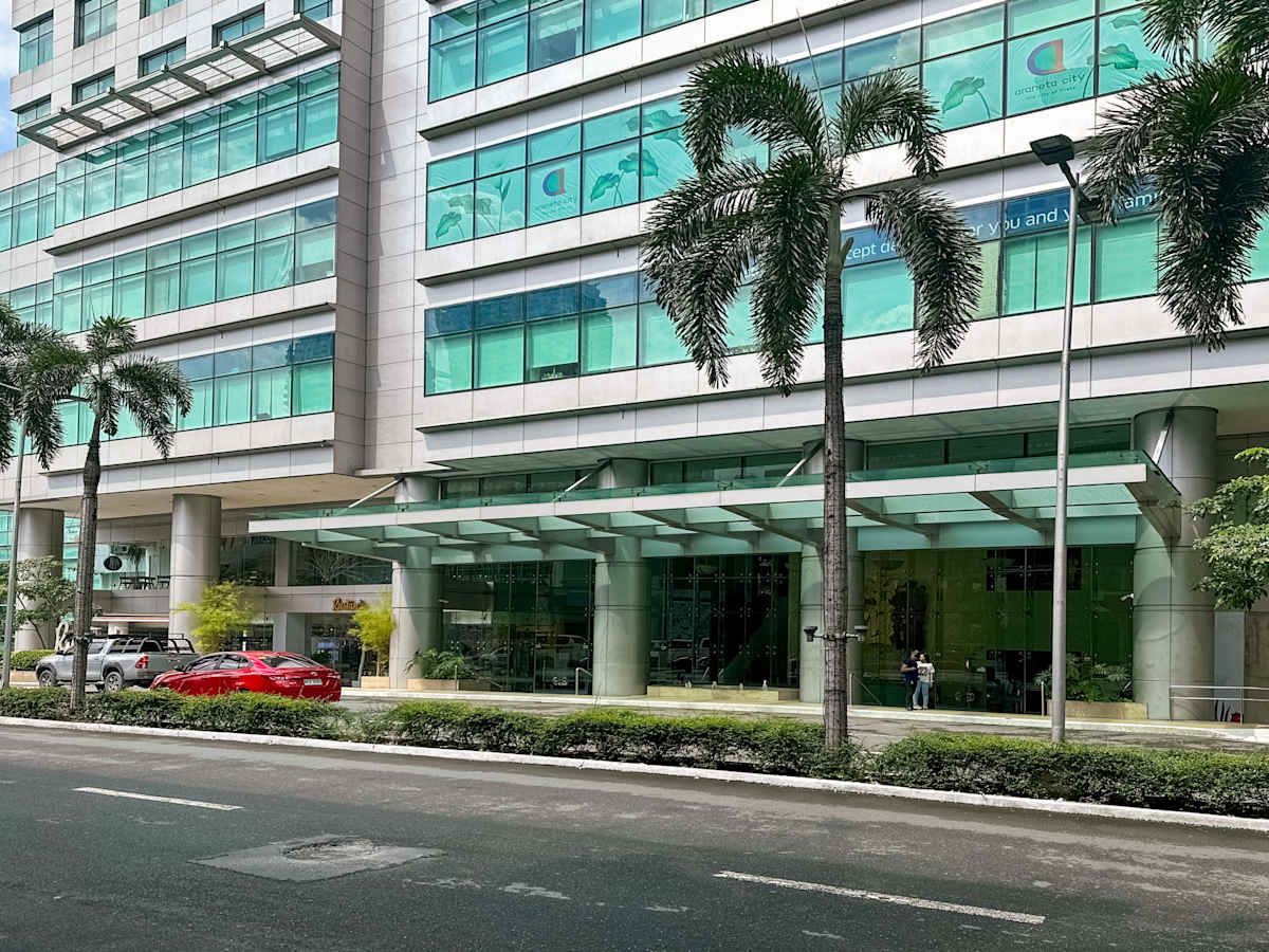 Modern office building with sleek glass facade and lush landscaping. Ideal for businesses.