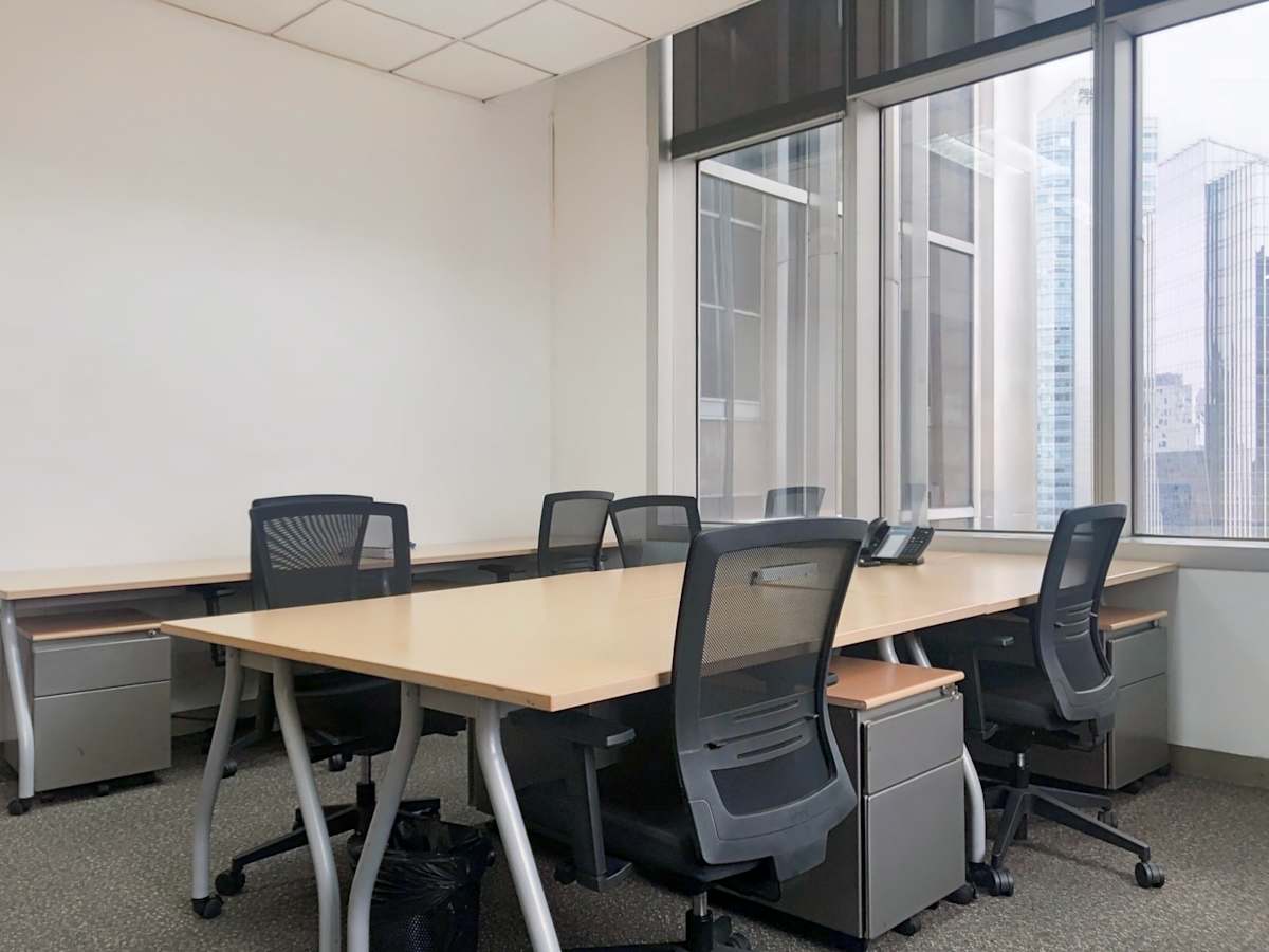Modern office with ergonomic chairs and ample natural light, ideal for productivity.